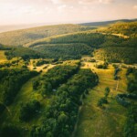 an aerial view of a lush green valley
