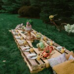 brown wooden picnic table on green grass field during daytime